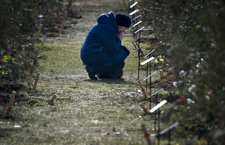 FILE – The mother of a Russian soldier who was killed in a military action in Ukraine, kneels near a planted tree in memory of her son at the Alley of Heroes in Sevastopol, Crimea, Saturday, Feb. 25, 2023. The Alley of Heroes was opened in memory of Russian servicemen who died during fighting in Ukraine. More than 70 trees were planted in the Victory Park. Nearly 50,000 Russian soldiers have died in the war in Ukraine, according to the first independent statistical analysis of Russia’s war dead. (AP Photo, File) XEST911 XEST911