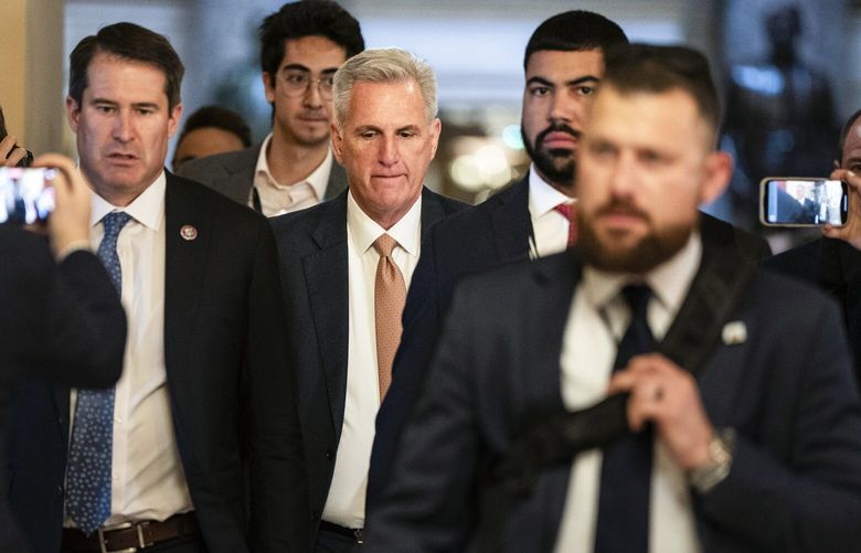 House Speaker Kevin McCarthy (R-Calif.) walks into a vote flanked by reporters on Capitol Hill in Washington, on Wednesday, July 12, 2023. A group of right-wing House Republicans pushing to load up the annual defense bill with socially conservative policies on abortion, race and gender have another demand: severe restrictions on U.S. military support for Ukraine. (Haiyun Jiang/The New York Times) XNYT0750 XNYT0750