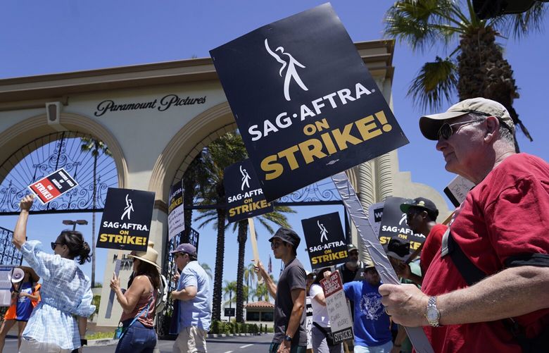 Striking writers and actors picket outside Paramount studios in Los Angeles on Friday, July 14, 2023. This marks the first day actors formally joined the picket lines, more than two months after screenwriters began striking in their bid to get better pay and working conditions. (AP Photo/Chris Pizzello) 