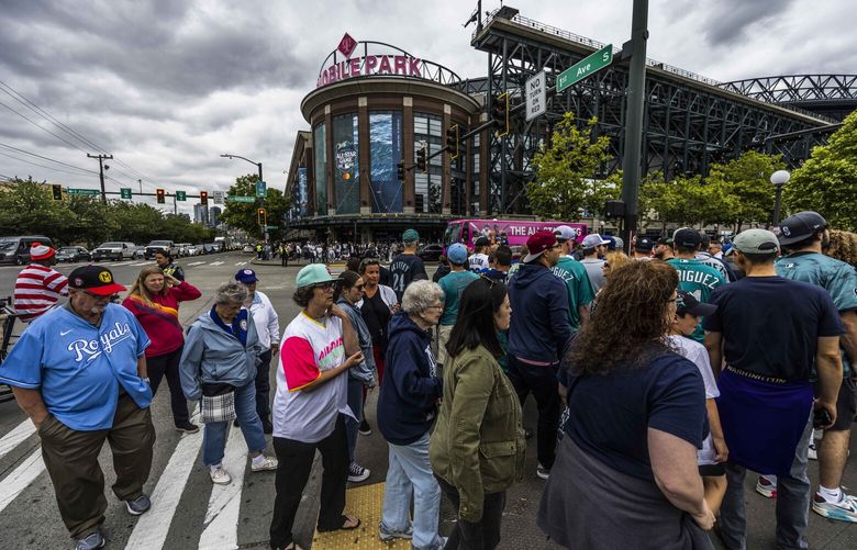 Hoards of fans wait to cross the street to enter the Home Run Derby at T-Mobile Park on July 10, 2023.