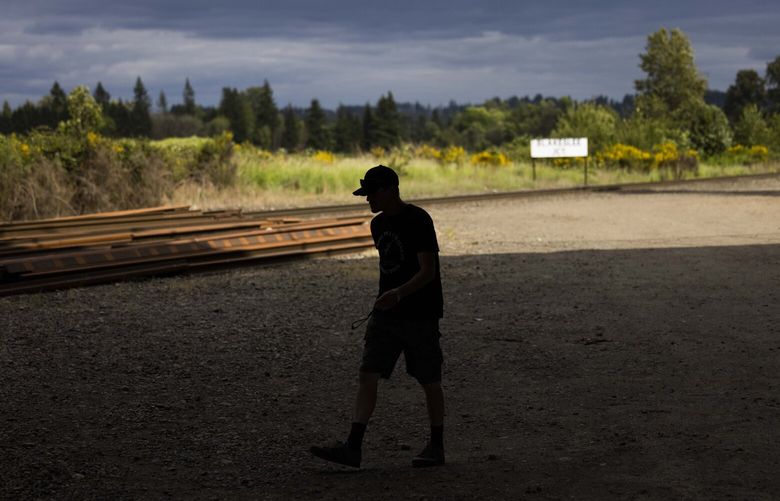 Derek Shaughnessy, Recovery Navigator program outreach worker, walks around near the Blakeslee Junction encampment offering services and outreach for community members on May 31, 2023.