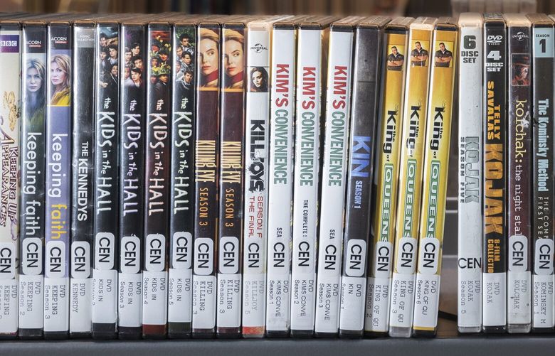 These are some of the favorites of el Evans, a librarian at the Central Library in downtown Seattle. Evans manages the DVD collection at the library and takes pride for  being accessible to more alternative folks who might not be comfortable approaching their co-workers.  Shot Monday, July 10, 2023.
 224331