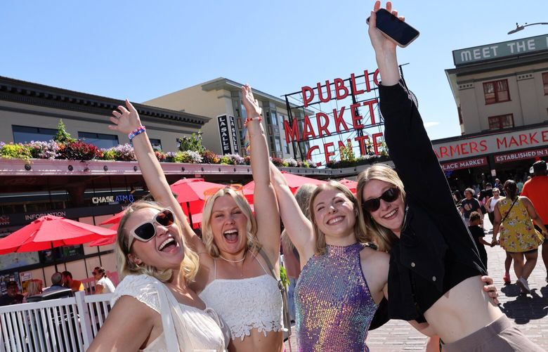 Taylor Swift fans from left to right: Maddy Gareau, Rosie Lee, Hannah Beaveridge, and Emily Whitacker, all from Vancouver Island, BC, Canada, ham it up for the camera while visiting Pike Place Market in Seattle on Saturday, July 22, 2023. Best friends from High School they are spending two nights in Seattle for a girl’s weekend. Many events around the city have led to thousands of people here for the weekend.  224524