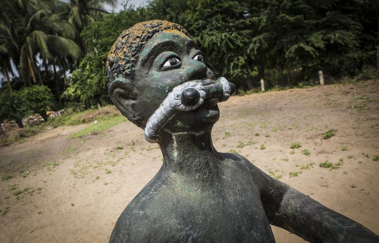 A statue of an enslaved person on Jan. 12, 2018, outside the Case of Zomai, a sealed hut where enslaved people were kept before reaching the Point of No Return, in Ouidah, Benin. MUST CREDIT: Photo for The Washington Post by Jane Hahn (Jane Hahn / For The Washington Post)
