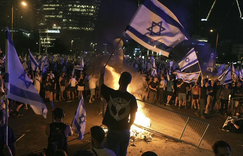 Demonstrators protest against plans by Prime Minister Benjamin Netanyahu’s government to overhaul the judicial system, in Tel Aviv, Monday, July 24, 2023. Israeli lawmakers on Monday approved a key portion of Prime Minister Benjamin Netanyahu’s divisive plan to reshape the country’s justice system despite massive protests that have exposed unprecedented fissures in Israeli society. (AP Photo/Oded Balilty) XOB414 XOB414