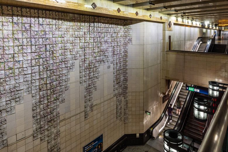 WESTLAKE STATION: A large section of the south station wall is sheathed in terra-cotta tiles of hanging vines and flowers created by Jack Mackie to visually bring Westlake Park below ground. (Kevin Clark / The Seattle Times)