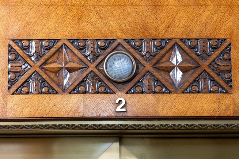 THE 1411 BUILDING: Detail above a polished brass elevator in the Honduran mahogany lobby. (Kevin Clark / The Seattle Times)