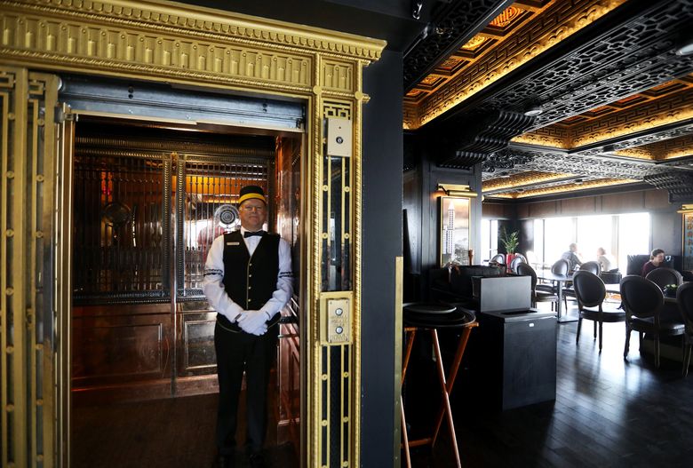 THE SMITH TOWER: Elevator operator Joe Teeples brings visitors up to the Smith Tower&#8217;s 35th floor, which has undergone several remodels and removal of original fittings. The building&#8217;s ornate elevators are trimmed with polished brass. (Ken Lambert / The Seattle Times, 2018)