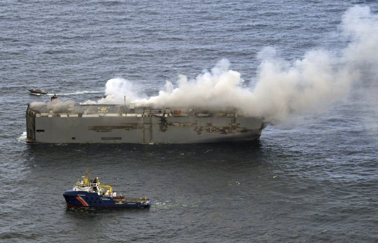 Smoke and flames are seen on a freight ship in the North Sea, about 27 kilometers (17 miles) north of the Dutch island of Ameland, Wednesday, July 26, 2023. A fire on the freight ship Fremantle Highway, carrying nearly 3,000 cars, was burning out of control Wednesday in the North Sea, and the Dutch coast guard said it was working to save the vessel from sinking close to an important habitat for migratory birds. (Kustwacht Nederland/Coastguard Netherlands via AP) LBL102 LBL102