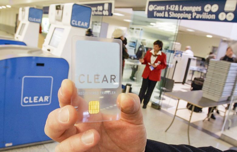 A Clear biometric identification card is displayed at a TSA checkpoint  during a demonstration of Clear’s airport kiosks, left, in the British Airways terminal of New York’s Kennedy Airport, Tuesday Jan. 16, 2007.  Operated by Verified Identity Pass Inc., the GE Security screening kiosks allows travelers who pay a $100 fee and undergo a background check to bypass a security line by inserting a biometric card in the kiosk that will scan their irises and fingerprint, and their footware for a bomb. Only the shoe-scanner has received Transporttation Security Administration approval for official use to date, so customers won’t get the fingertip scan feature, at least initially. (AP Photo/Richard Drew) NYRD104