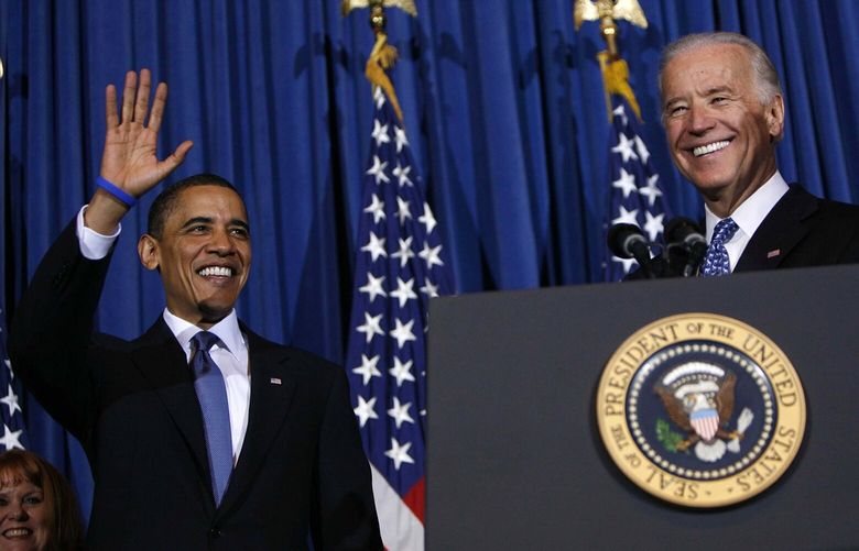 U.S. President Barack Obama (left) and Vice President Joe Biden smile and wave at a rally celebrating the final passage of the Patient Protection and Affordable Care Act on March 23, 2010, in Washington, DC. (Dennis Brack/Pool/Getty Images/TNS)