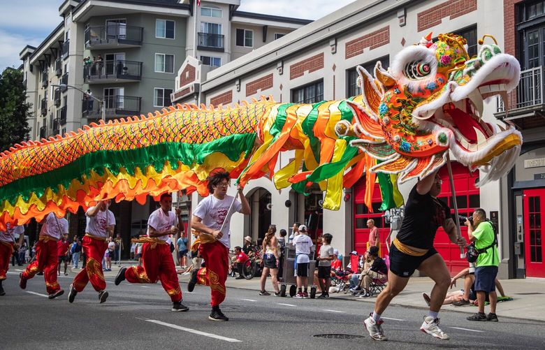 The Seattle Chinatown Dragon Team charges down 4th Av. Saturday, July 29, 2023, during the Alaska Airlines Seafair Torchlight Parade in downtown Seattle. 224582