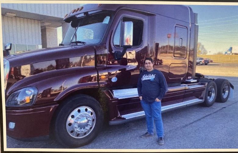 A printed photo of Davi Pedro in front of his semi-truck he recently sold. (Courtesy of Davi Pedro)