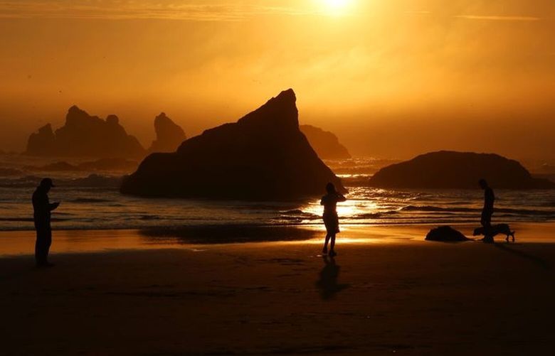The sun sets over Face Rock State Scenic Viewpoint in Bandon on the southern Oregon coast.