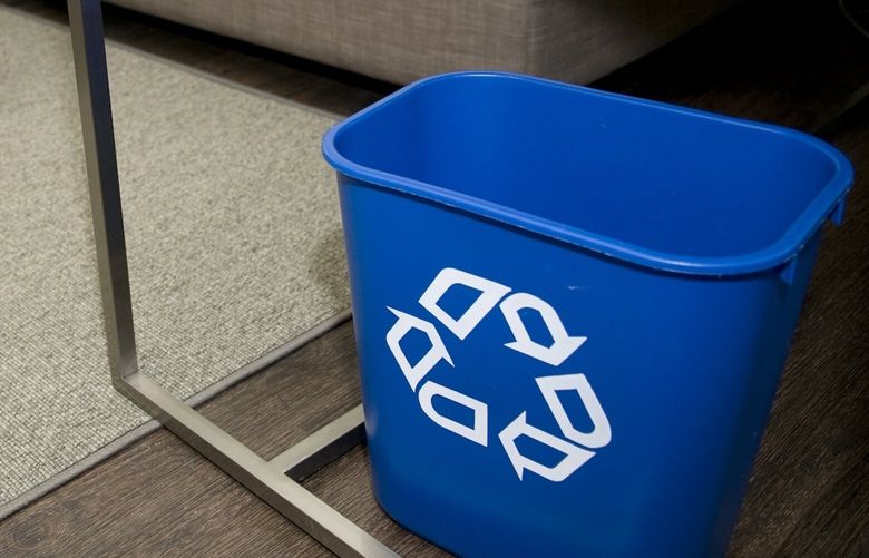 FILE — A recycling bin carries the recycling symbol at a hotel room in Lexington, Mass., Sept. 18, 2009. The environmental agency that oversees recycling efforts wants to stop using the “chasing arrows” logo on plastics that can’t be recycled. The man who designed it more than 50 years ago agrees that the symbol has been misused. (Jodi Hilton/The New York Times) XNYT0910 XNYT0910