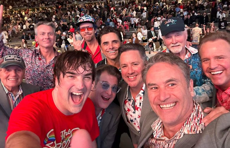 Auburn drummer Jon Bolton, bottom left, is seen earlier this summer on tour with The Beach Boys. The veteran Seattle musician, who has played in Seattle cover band The Beatniks for years, was discovered by de facto Beach Boy John Stamos on Instagram.