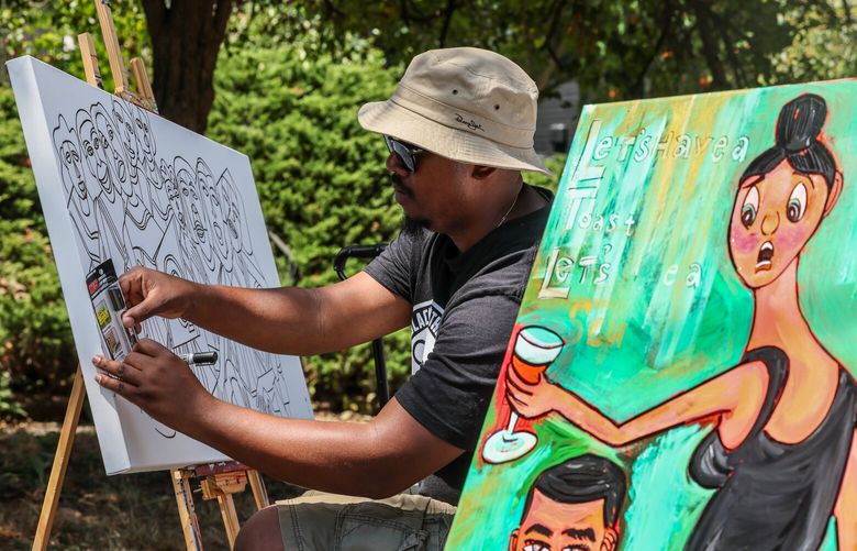 Rodney King works on a piece Saturday afternoon during the Books, Bites N’ Beats art market in the Central District in Seattle, Washington on July 29, 2023