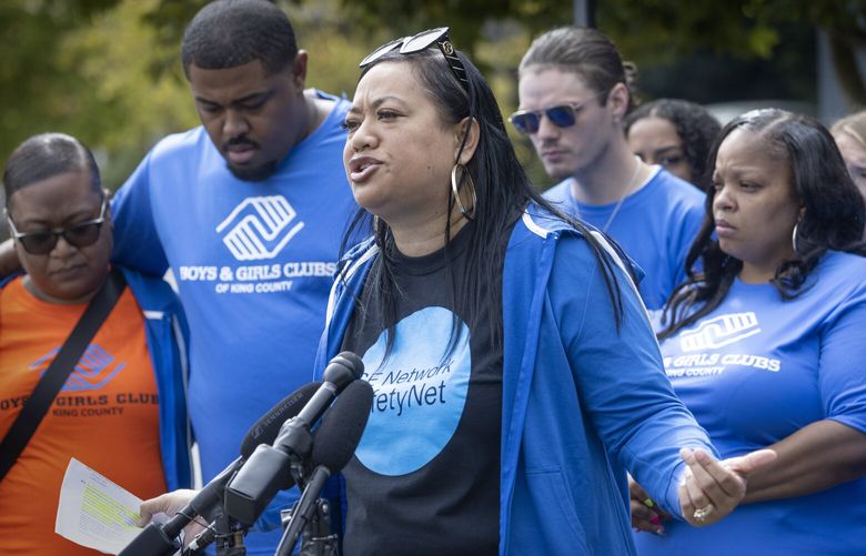 Marty Jackson, (center) the executive director of the SE Network SafetyNet Program, speaks in the Rainier Beach Safeway parking lot at 9262 Rainier Ave S. in front of her team from the Boys & Girls Clubs of King County Thursday, August 10, 2023.  Jackson is addressing the shooting that occurred at the Rainier Beach Safeway parking lot on Friday night, July 28th. The incident occurred during the SE Network’s Community Healing Space Activation, which works to directly oppose, address, and deter such acts of violence.  Five individuals were injured, including two staff from the SE Network Safe Passage Team at Boys & Girls Clubs of King County.  Second from left is D’mario Mallory, who was shot in the back at the event.  After he was shot, he still tried to help others.  He has his arm around his wife.

The group plans to return to the parking lot to host the community healing spaces after being absent last Friday, a week after the shootings. There is still no word on any arrests.


 224692