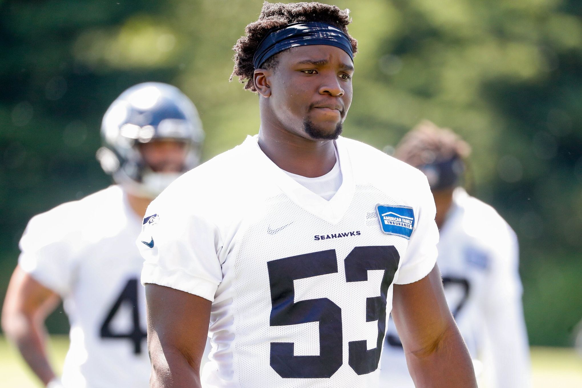 Seattle Seahawks linebacker Jon Rhattigan walks off the field with his  helmet off after playing the