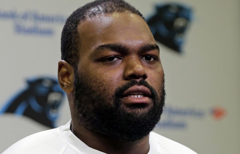 FILE – Carolina Panthers’ Michael Oher speaks to the media during the first day of their NFL football offseason conditioning program in Charlotte, N.C., April 20, 2015. Oher, the former NFL tackle known for the movie “The Blind Side,” filed a petition Monday, Aug. 14, 2023, in a Tennessee probate court accusing Sean and Leigh Anne Tuohy of lying to him by having him sign papers making them his conservators rather than his adoptive parents nearly two decades ago.(AP Photo/Chuck Burton, File) NY179 NY179