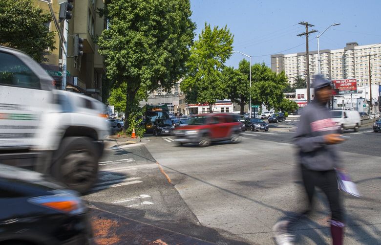Cars and pedestrians cross the intersection of Denny Way and Stewart Street on Thursday, August 10, 2017 in South Lake Union. 203125