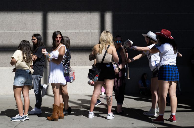 Die-hard Swifties wait in line hours for early merch sales at Lumen Field