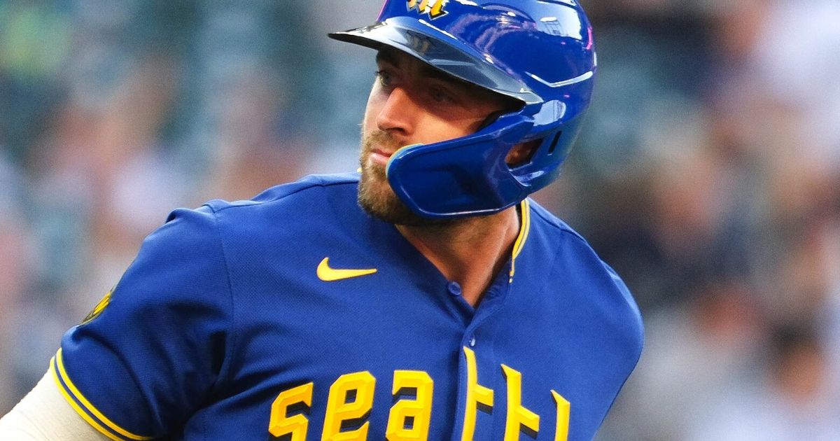 Seattle Mariners' Tom Murphy reacts in the dugout after he hit a