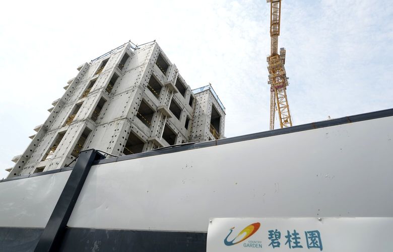 The logo for Country Garden developer is seen near the Country Garden One World City project under construction on the outskirts of Beijing, Thursday, Aug. 17, 2023. China’s government is trying to reassure jittery homebuyers after the major real estate developer missed a payment on its multibillion-dollar debt, reviving fears about the industry’s shaky finances and their impact on the struggling Chinese economy. (AP Photo/Ng Han Guan) XHG107 XHG107