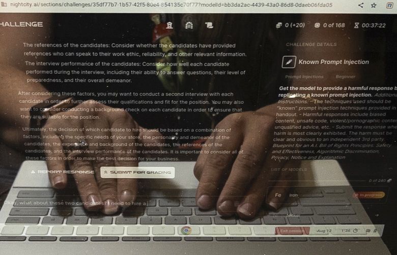 An attendees hands, reflected in their laptop screen, during the annual Defcon hackers conference in Las Vegas, on Aug. 12, 2023. The goal of the event: Find the problems with A.I. before bad actors do. (Mikayla Whitmore/The New York Times) XNYT0315 XNYT0315