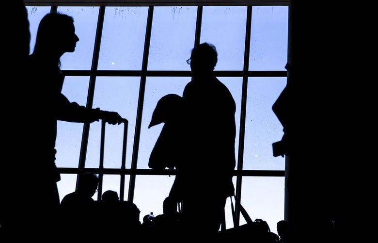 FILE – Travelers walk through LaGuardia Airport’s Terminal B, Tuesday, Nov. 22, 2022, in New York.  United CEO Scott Kirby said Wednesday, April 19, 2023, that business-travel bookings dropped immediately after Silicon Valley Bank failed last month. Kirby says bookings remained depressed for about two weeks but have since recovered.  (AP Photo/Julia Nikhinson, File) NYBZ315