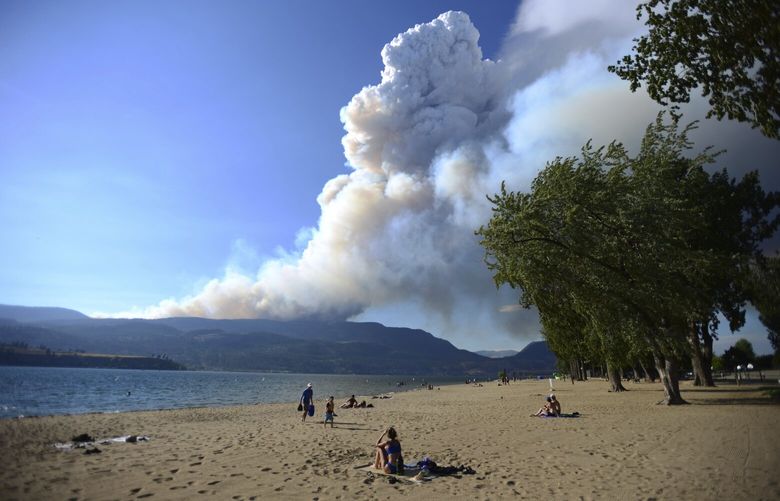 Smoke from the McDougall Creek fire is seen over Okanagan Lake from Kelowna, British Columbia, on Thursday, Aug. 17, 2023. (Joe O’Connal/The Canadian Press via AP) JCO106 JCO106