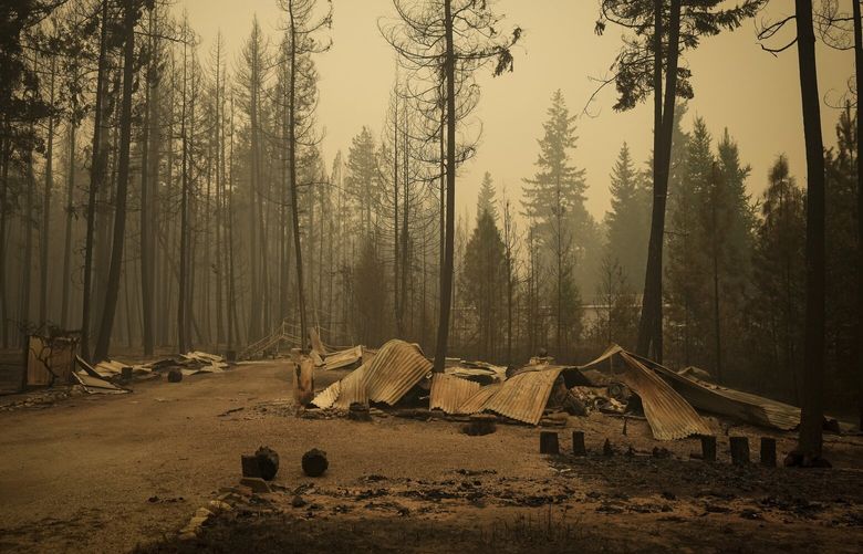 The remnants of a property that was destroyed by the Lower East Adams Lake wildfire litters the ground in Scotch Creek, British Columbia, on Sunday, Aug. 20, 2023. (Darryl Dyck/The Canadian Press via AP) 