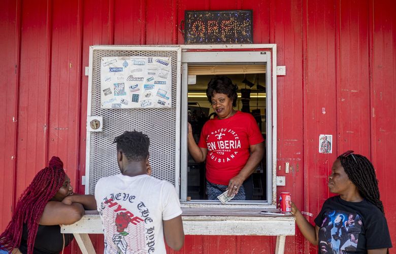 Linda Vitto serves cold drinks to customers at Grab-N-Go, a convenience store in New Iberia, La., on Aug. 5, 2023. It’s not just the heat, as Southerners have explained for generations. It’s the moist, soupy, suffocating humidity. And this year the punishing conditions have been relentless. (Emily Kask/The New York Times) XNYT0182 XNYT0182