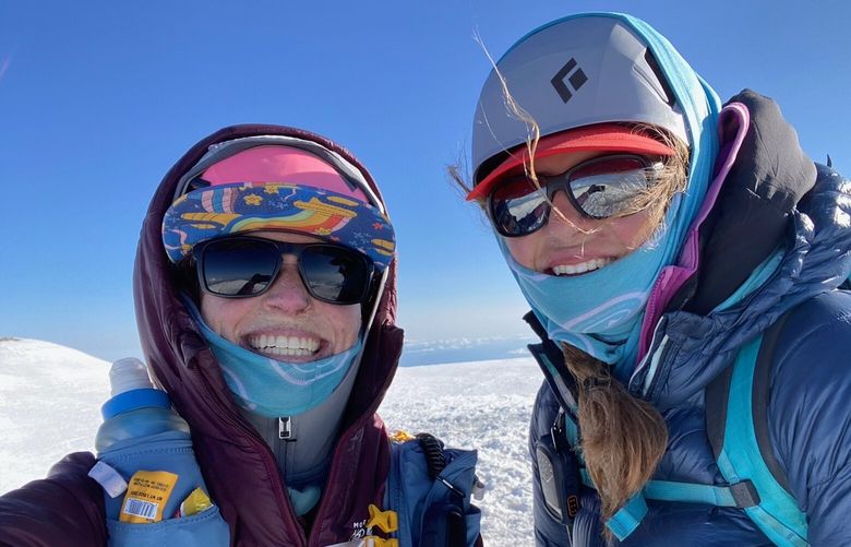 Abby Westling, left, and Kiira Antenucci celebrate their record Infinity Loop run with a selfie on Mount Rainier. It was their second successful summit bid in 49 hours.