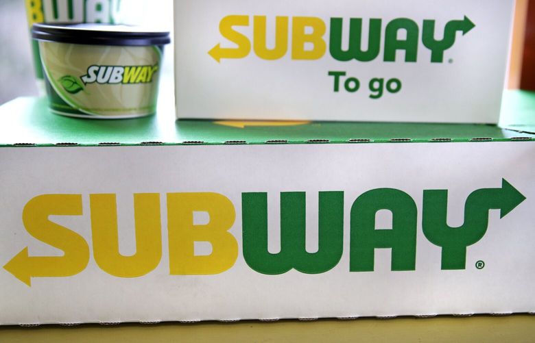 File – The Subway logo is seen on takeout boxes at a restaurant in Londonderry, N.H., on Feb. 23, 2018. The sandwich chain said Thursday it will be sold to the private equity firm Roark Capital. Terms of the deal weren’t disclosed. (AP Photo/Charles Krupa, File) NYPM403 NYPM403
