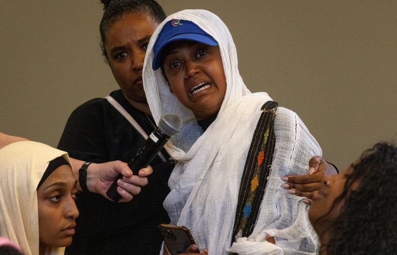 Saba Desta, of New York City, who is is a childhood friend of Nadia Kassa, who died of multiple gunshot wounds at Rainier Hookah Lounge, speaks during a community safety meeting, Wednesday night, Aug. 23, 2023 at Rainier Beach Community Center in Seattle. At lower left is Fedilla Kassa, of Kent, who is a sister of Nadia.