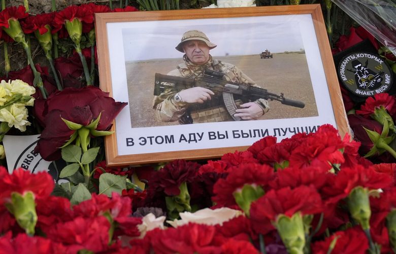 An image of the owner of private military company Wagner Group, Yevgeny Prigozhin, with words in Russian ‘In this hell you were the best’ lies at an informal memorial next to the former ‘PMC Wagner Centre’ in St. Petersburg, Russia, Friday, Aug. 25, 2023. A preliminary U.S. intelligence assessment has found that the plane crash presumed to have killed Wagner leader Yevgeny Prigozhin was intentionally caused by an explosion. (AP Photo/Dmitri Lovetsky) XDL112 XDL112