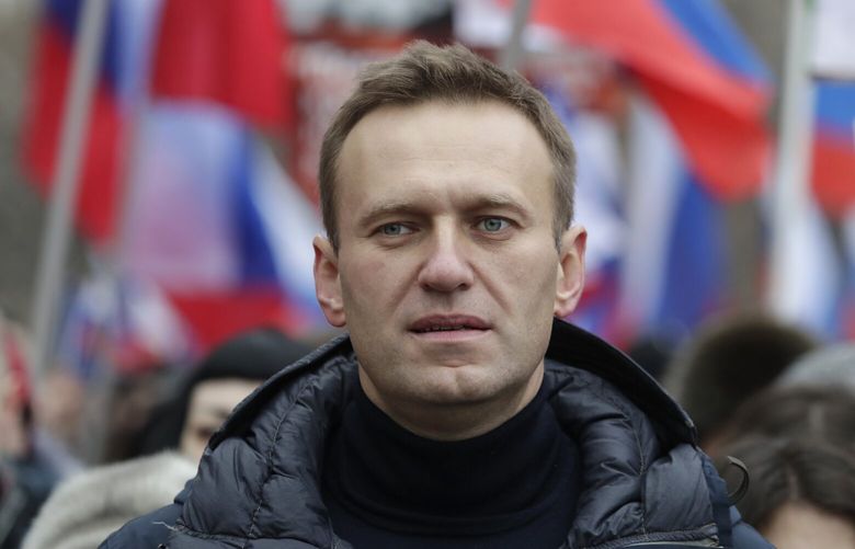 FILE – In this Sunday, Feb. 24, 2019 file photo, Russian opposition activist Alexei Navalny takes part in a march in memory of opposition leader Boris Nemtsov in Moscow, Russia. In August 2020, the opposition leader fell ill on a flight from Siberia to Moscow. The plane landed in the city of Omsk, where Navalny was hospitalized in a coma. Two days later, he was airlifted to Berlin, where he recovered. (AP Photo/Pavel Golovkin, File) XKS401 XKS401