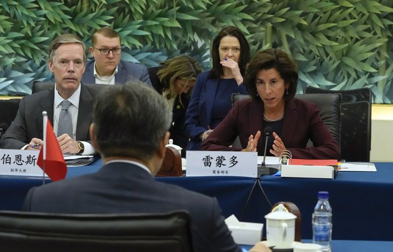U.S. Commerce Secretary Gina Raimondo, right, speaks next to U.S. Ambassador to China Nick Burns, left, during a meeting with China’s Minister of Commerce Wang Wentao, foreground, at the Ministry of Commerce in Beijing, Monday, Aug. 28, 2023. (AP Photo/Andy Wong, Pool) XAW101 XAW101