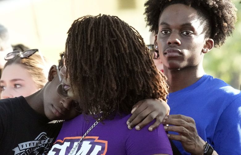 Residents gather at a prayer vigil for the victims of a mass shooting a day earlier, in Jacksonville, Fla., Sunday, Aug. 27, 2023. (AP Photo/John Raoux) FLJR220 FLJR220