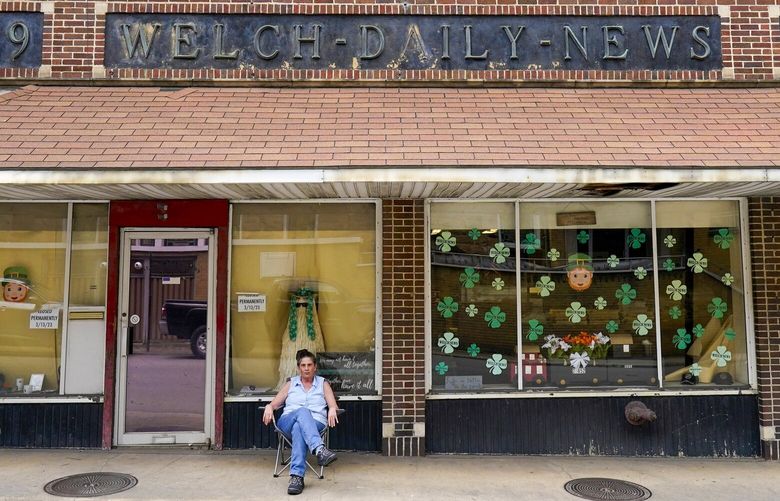 Missy Nester owner of the The Welch News sits in front of the now closed office on Wednesday, May 31, 2023, in Welch, W.Va. In March, the weekly publication in McDowell County one of the poorest counties America became another one of the quarter of all U.S. newspapers that have shuttered since 2005, a crisis Nester called “terrifying for democracy” and one that disproportionately impacts rural America. (AP Photo/Chris Carlson) WVCC501
