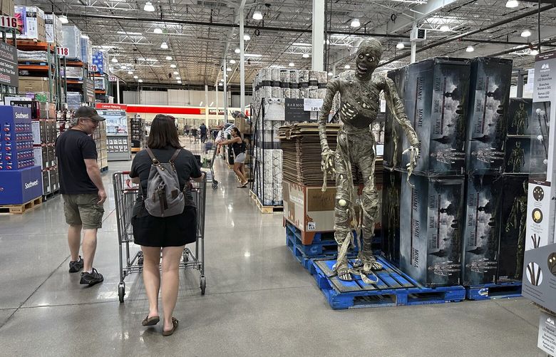 Shoppers pass a display of Halloween goods in a Costco warehouse on  Aug. 4, 2023, in Thornton, Colo. (AP Photo/David Zalubowski) 