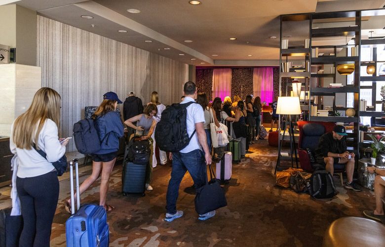 The line at the Renaissance Seattle hotel reception desk was long on Sunday, July 23, with one Taylor Swift show on Saturday and the next Sunday. The star’s visit is credited with helping to revitalize downtown Seattle, at least temporarily.  (Ken Lambert / The Seattle Times)