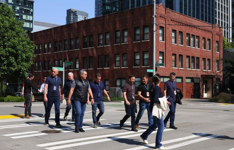Officers workers and tourists on the streets of the South Lake Union business district in Seattle, Washington on August 25, 2023.
 224834 224834