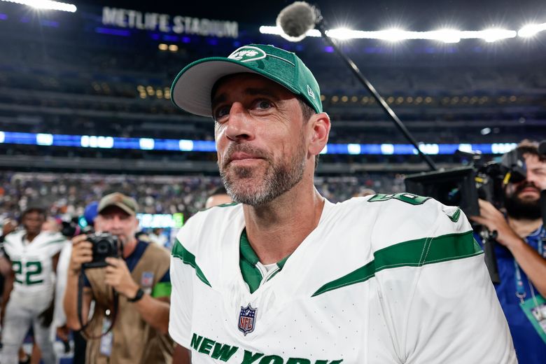 New York Jets quarterback Aaron Rodgers (8) stands on the sidelines during  the first half of an NFL preseason football game against the New York Giants,  Saturday, Aug. 26, 2023, in East