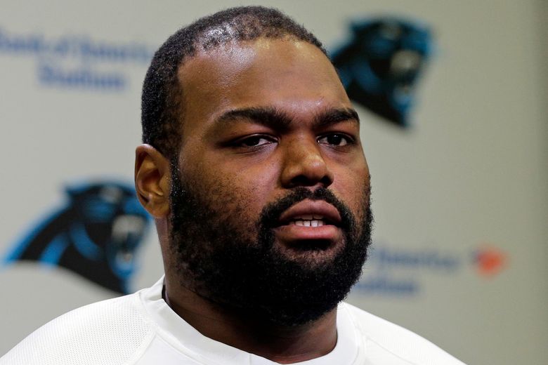 Michael Oher signs When Your Back's Against the Wall