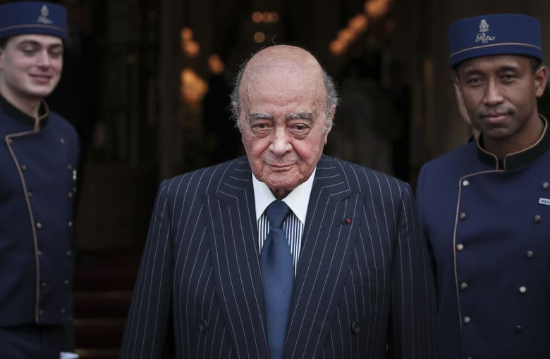 Egyptian businessman and Ritz hotel owner Mohamed Al Fayed poses with his hotel staff in Paris, June 27, 2016. Al Fayed, the former Harrods owner whose son Dodi was killed in a car crash with Princess Diana, has died at age 94. His death was announced Friday, Sept. 1, 2023, by Fulham Football Club, which Al Fayed once owned. (Kamil Zihnioglu / The Associated Press)