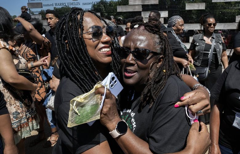 Organizers Julie Hawkins Ennis, left, and Rochell Prater, center, embrace during Saturday’s reunion. MUST CREDIT: Washington Post photo by Bill O’Leary