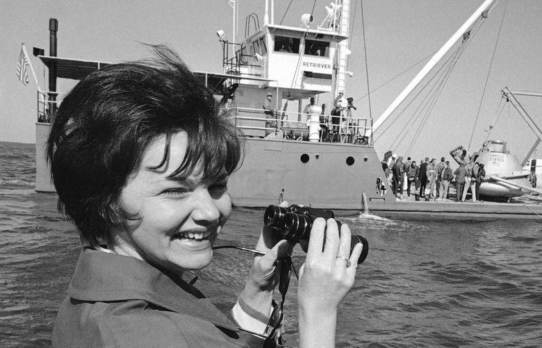 Mrs. Marilyn Lovell, wife of Capt. James A. Lovell, Jr., who is commander of Apollo 8, watches from a nearby boat as the NASA motor vessel Retriever gets ready to drop a mock-up of the command module into the water during a training period, Oct. 25, 1968. The Apollo 8 crew practiced egress and helicopter pickups in the Gulf of Mexico while the Apollo 7 crew was holding debriefing sessions following their successful orbital flight. (AP Photo/Fred Kaufman)