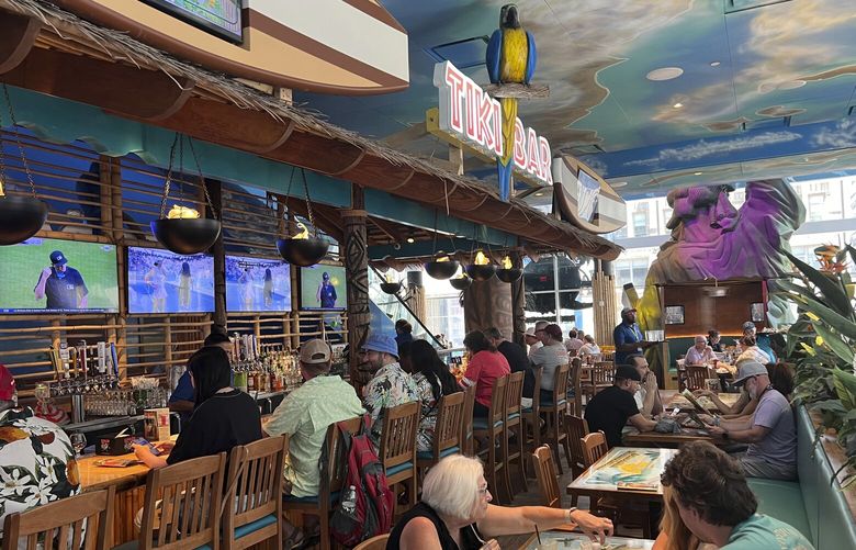 Patrons sit in the Margaritaville restaurant in New York’s Times Square on Saturday, Sept. 2, 2023, following news of the death of Jimmy Buffett. (AP Photo/Bobby Caina Calvan) 